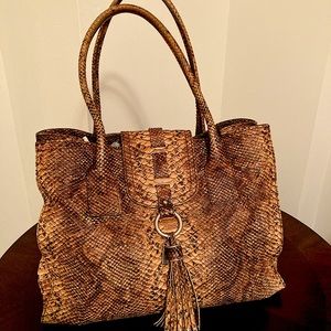 Stuart Weitzman genuine snake leather, designer’s logo, printed designer’s name.